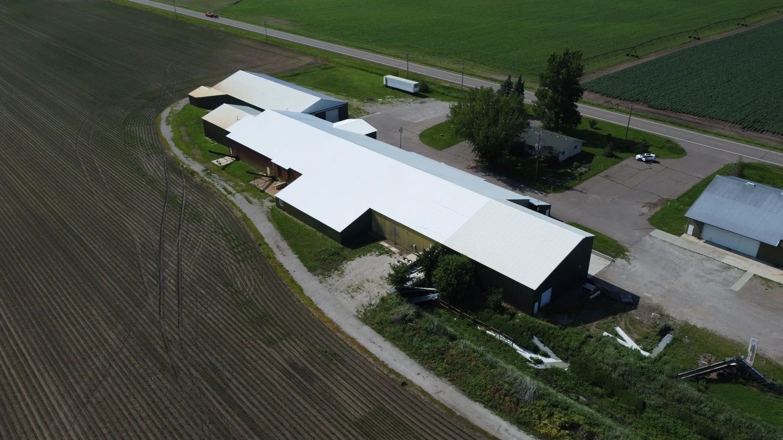 The full length of the bright standing seam roof running the length of the pole building
