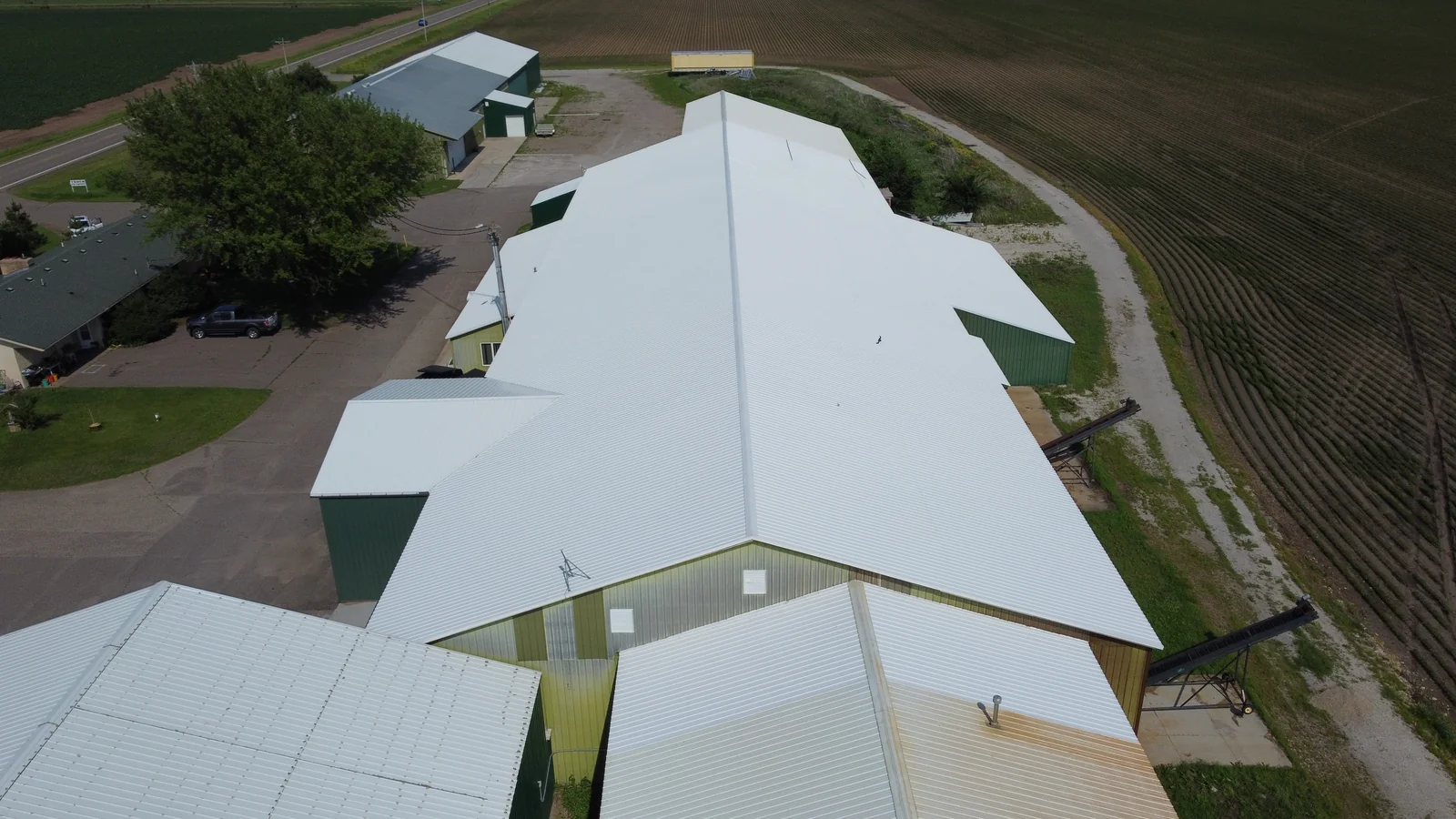 Two standing seam roof planes meeting along the building's ridgeline