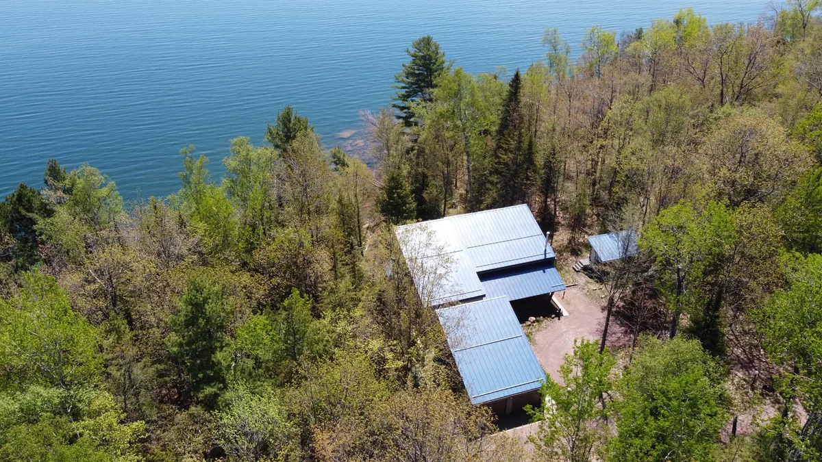 Modern home with a blue standing seam metal roof overlooking Lake Superior near Bayfield, WI