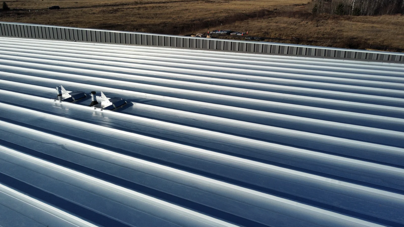 Close overhead look at the ribbed seams of the blue standing seam roof