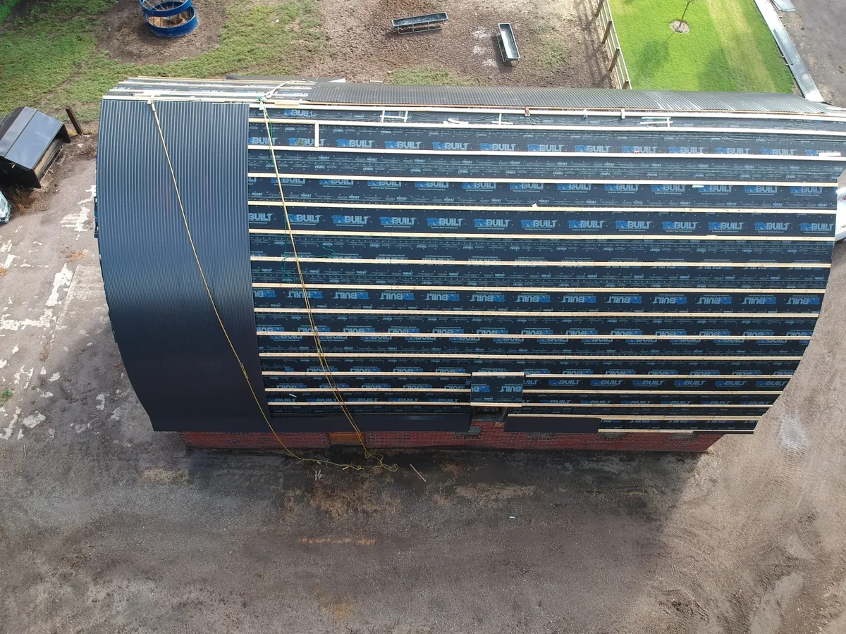 End-on view of the roof with the raised metal seams and battens clearly visible