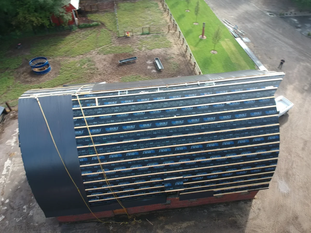 Overhead view of the rounded roof end showing the smooth dark metal panels
