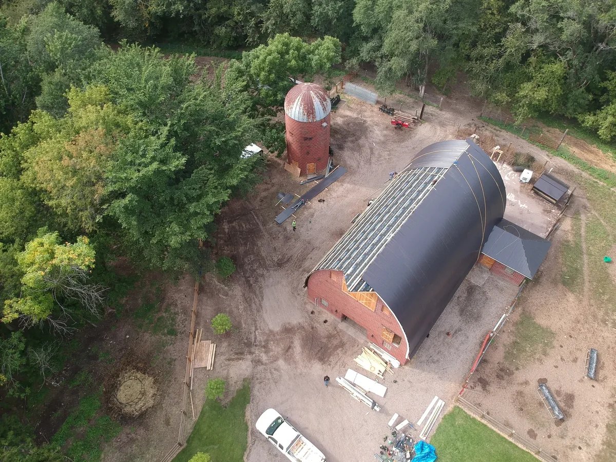 Close overhead detail of the standing seam ribs being installed across the curve