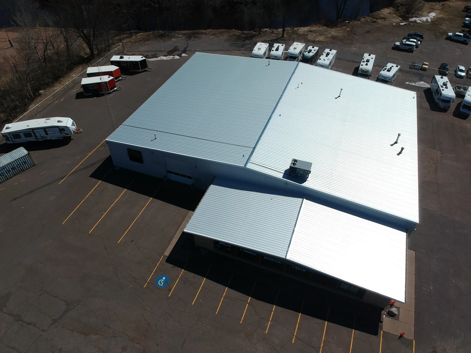 Aerial view of a large white metal recover roof on a commercial RV dealership in Hutchinson, MN