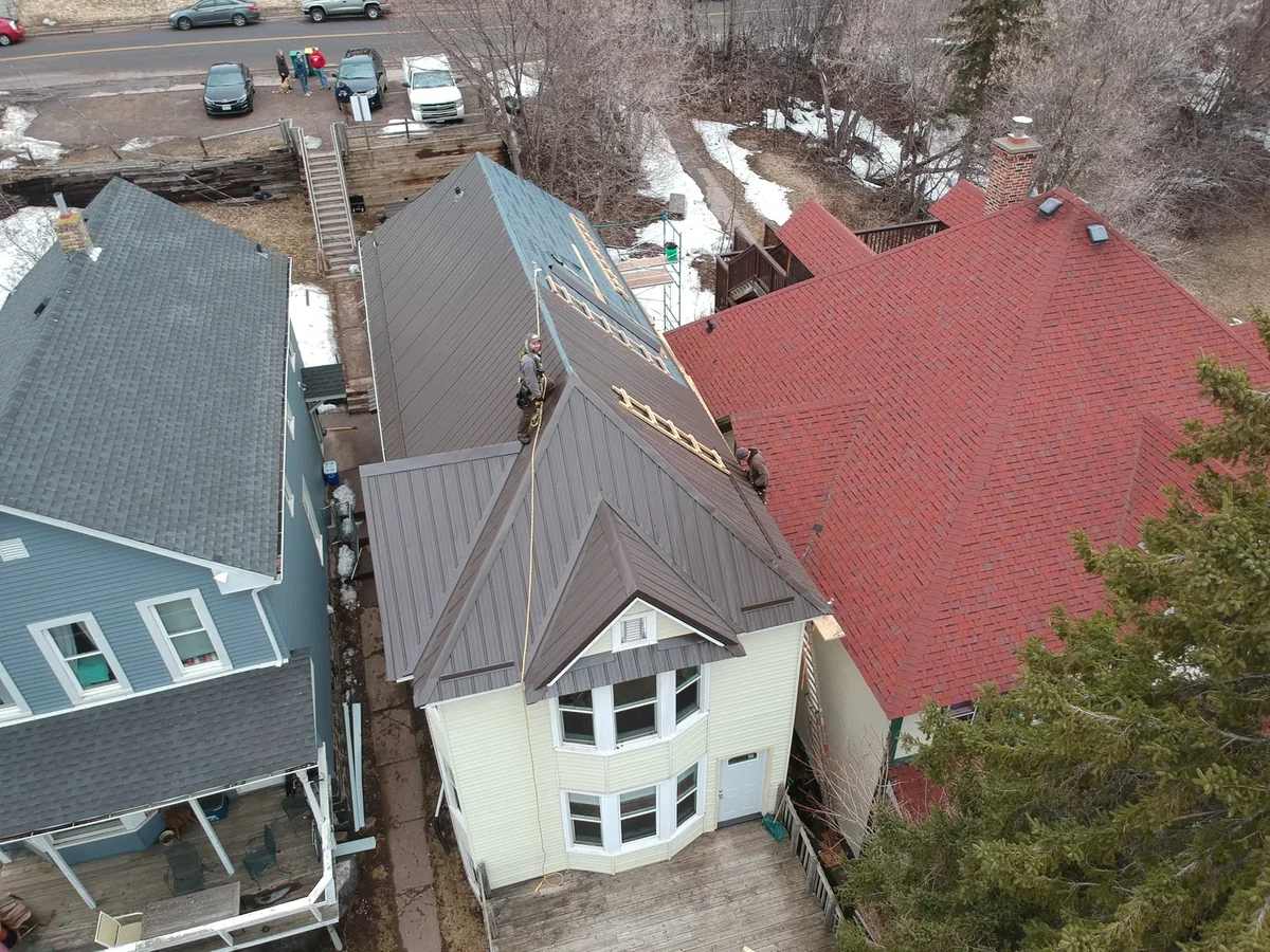 Closer look at the bronze metal roof above the bay window and front entry