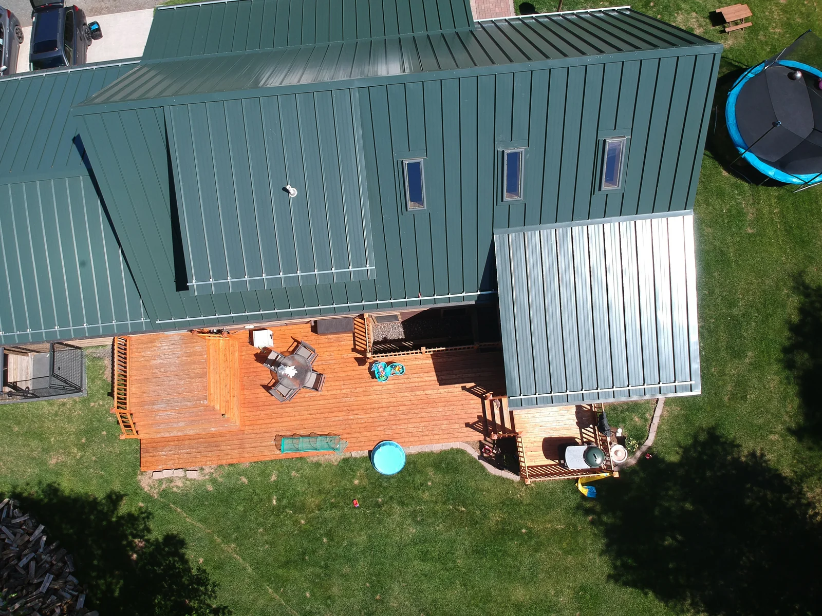 Overhead view of the green standing seam roof and backyard deck