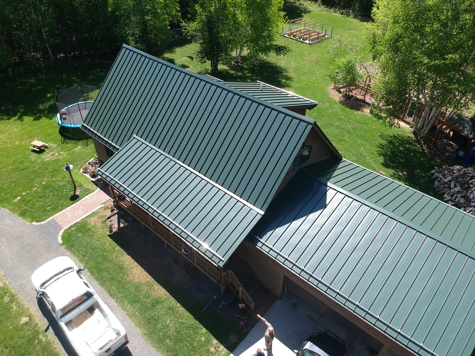 Close aerial of the green standing seam panels and ridgeline