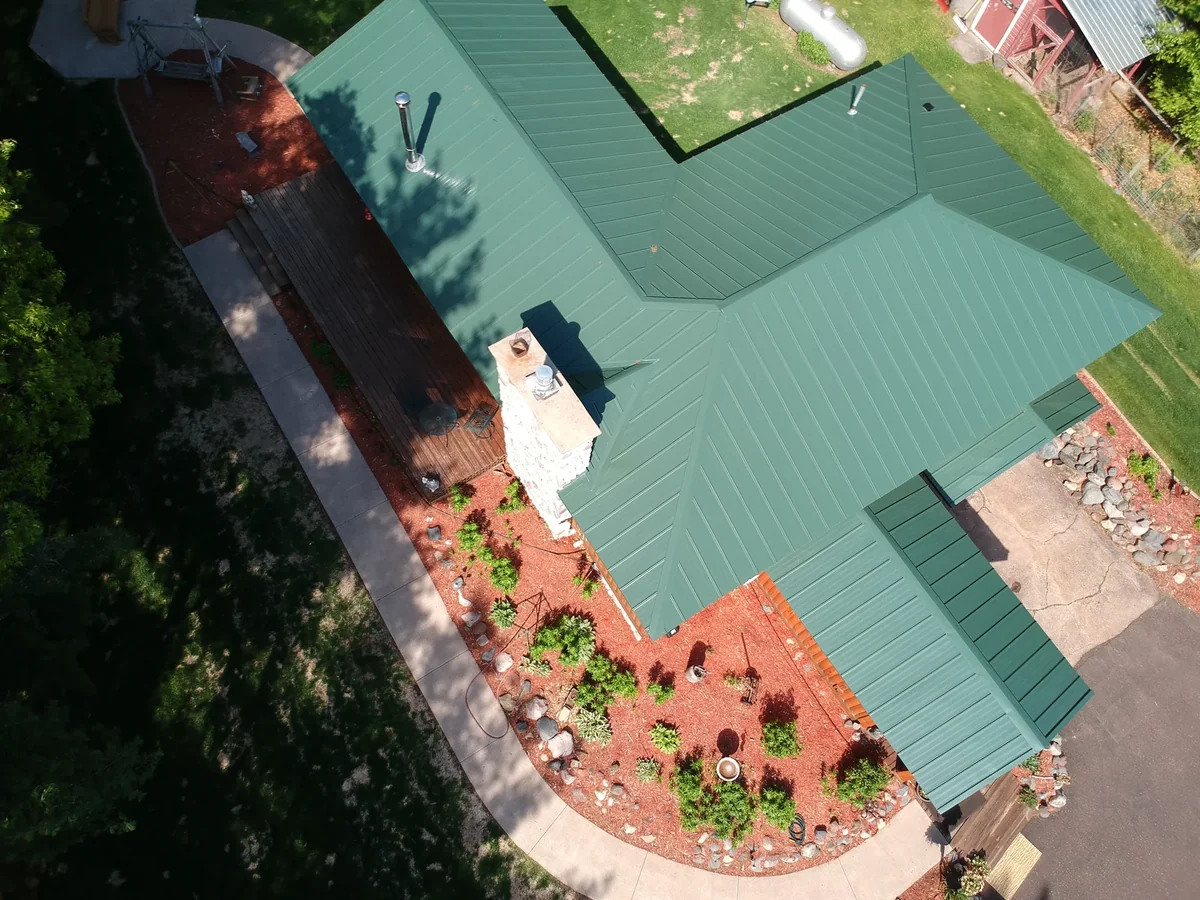 Overhead shot of the green metal roof showing its many gables and ridge lines.